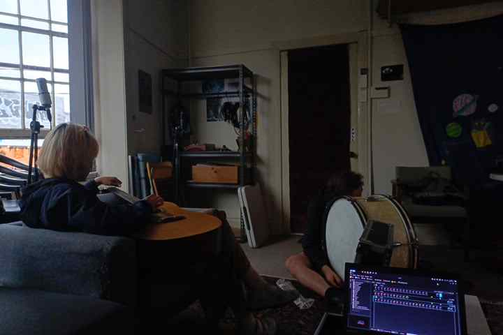 dahong playing guitar, laptop in the foreground